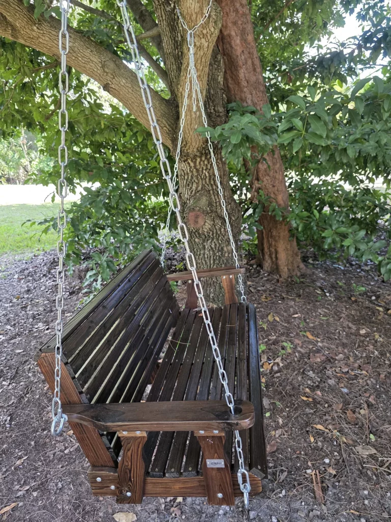 Wooden swing hanging from a tree, perfect for a peaceful treehouse stay and relaxing moments in nature at a treehouse getaway