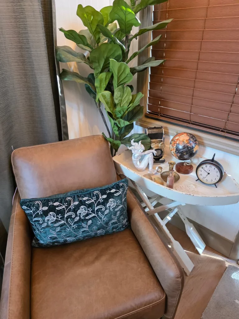 Cozy reading nook inside a Florida treehouse rental featuring a leather armchair and decor, perfect for treehouse getaways.