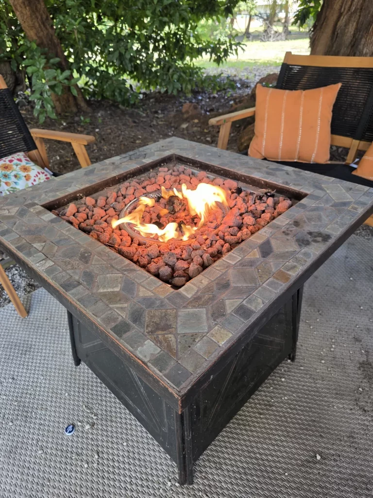 Cozy fire pit with seating at SunnyTops Treehouse. Perfect for romantic treehouse getaways and relaxing evenings.