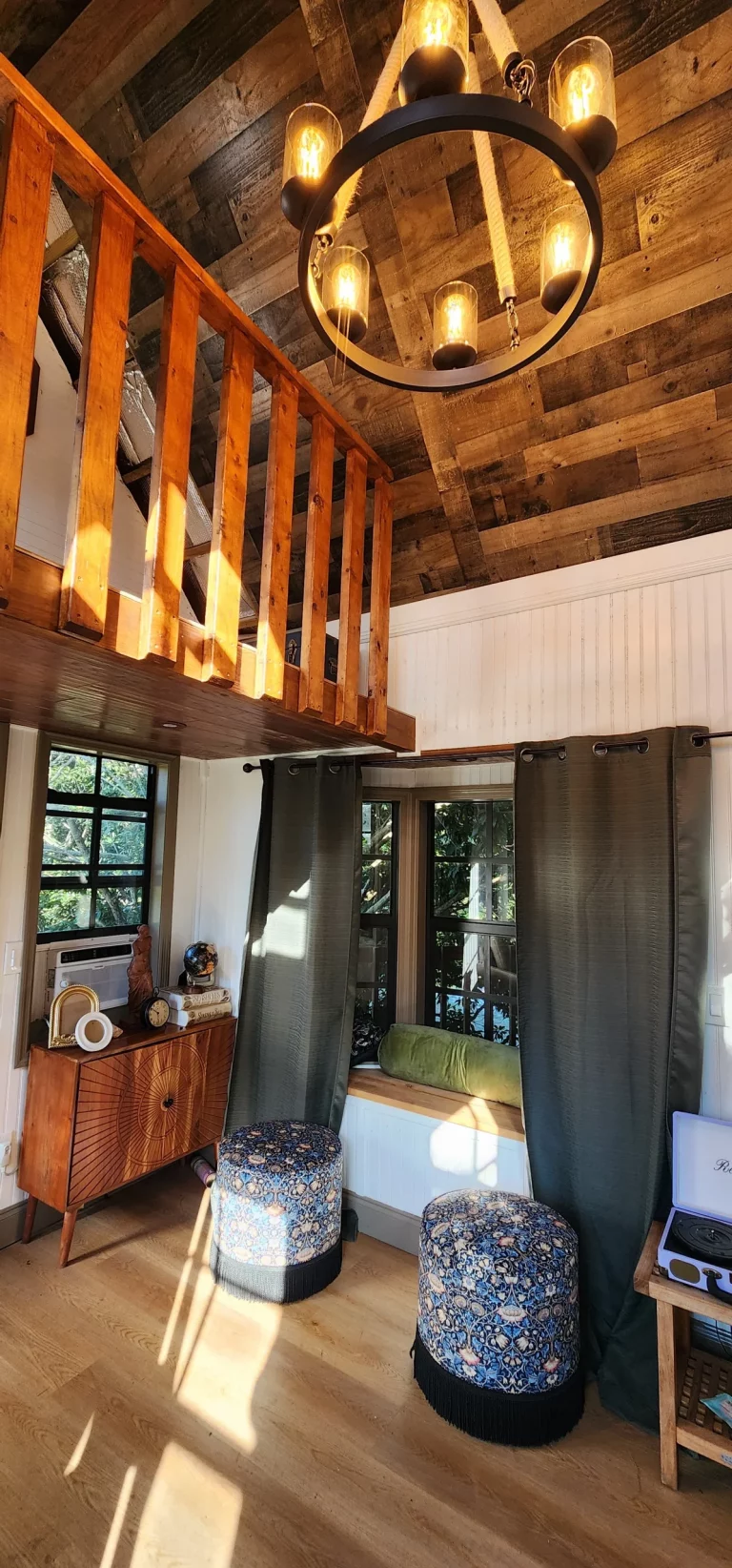 Interior of a cozy treehouse rental with wooden stairs and inviting decor, perfect for a treehouse getaway in Florida.