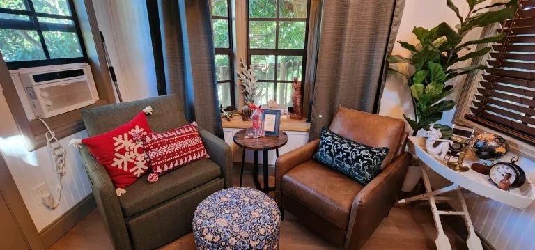 Cozy treehouse interior featuring comfortable seating, decorative pillows, natural light and a charming, relaxing getaway spa