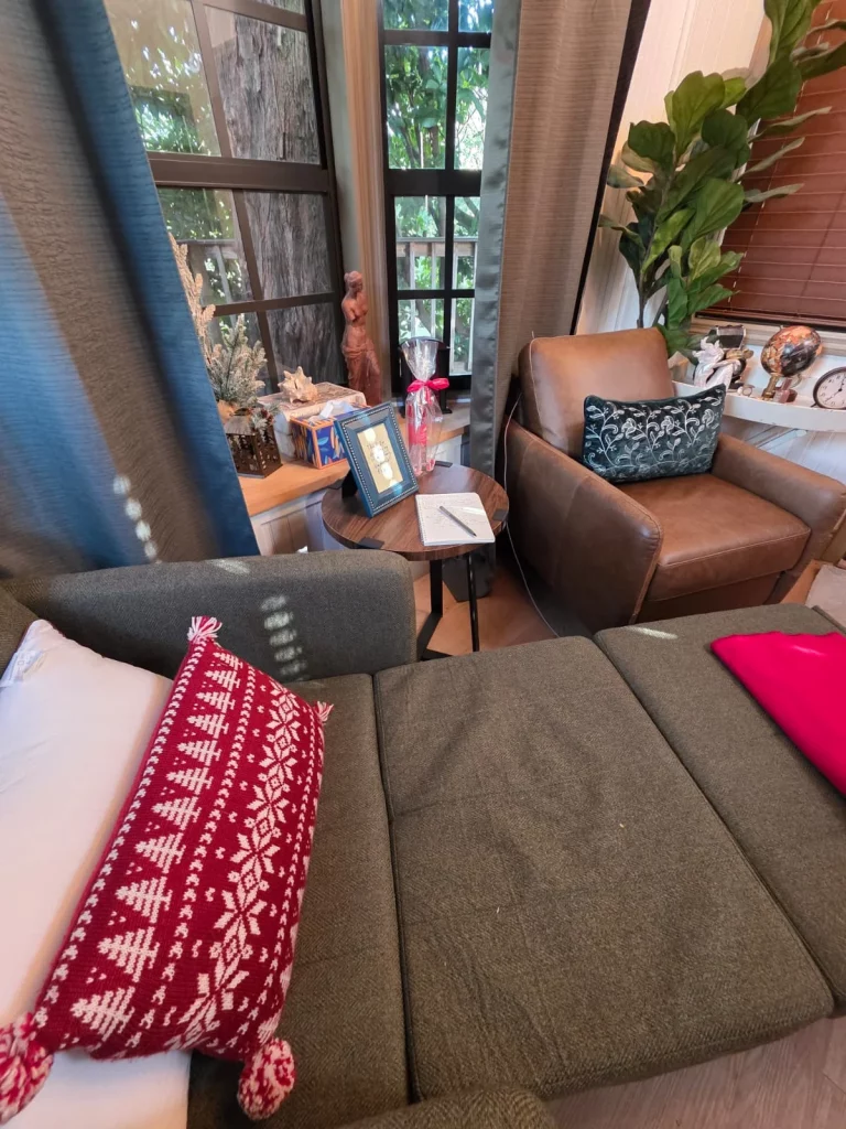 Cozy treehouse interior: inviting seating area with natural light, perfect for romantic treehouse getaways in Florida.