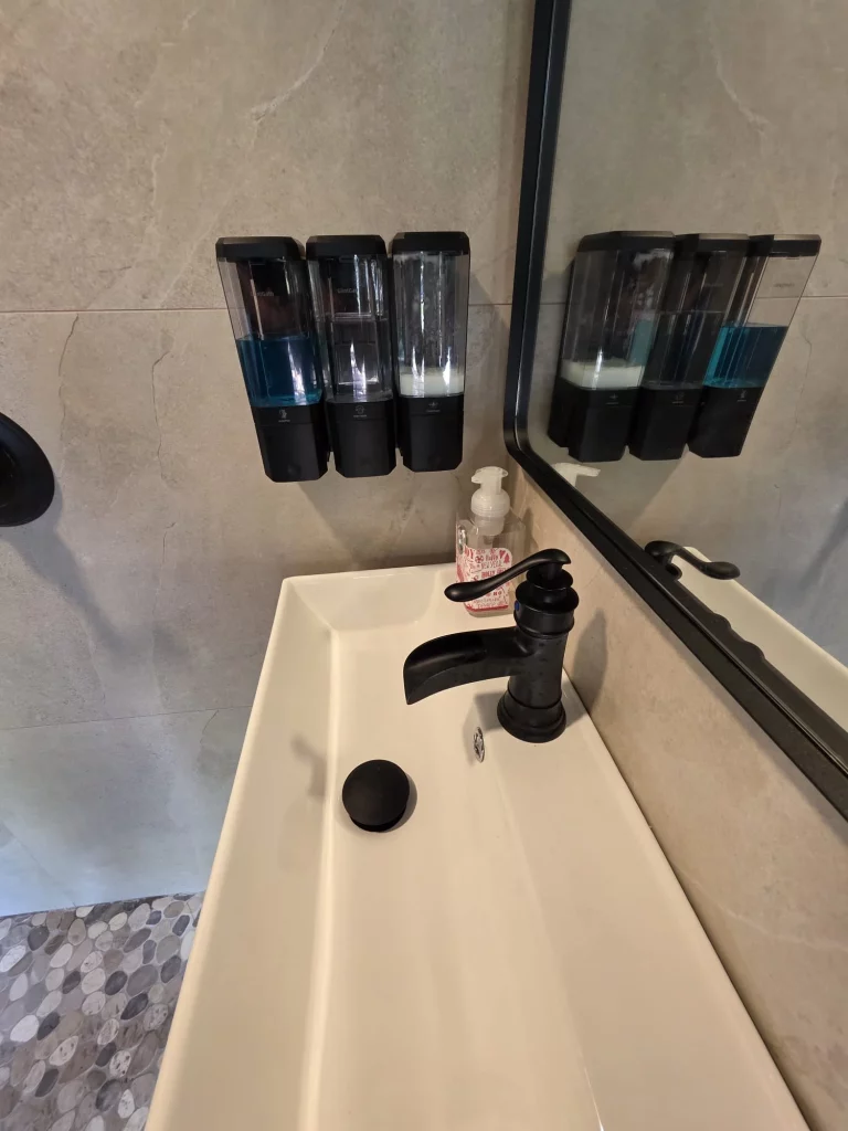 Modern bathroom sink and mirror in SunnyTops treehouse rental, a perfect treehouse getaway in Florida, with included toiletri