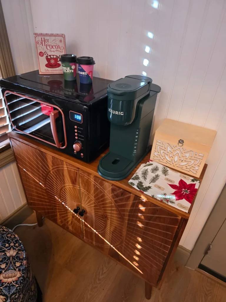 Cozy treehouse kitchen area with coffee maker, microwave, and decorative touches, perfect for a treehouse getaway in Florida.